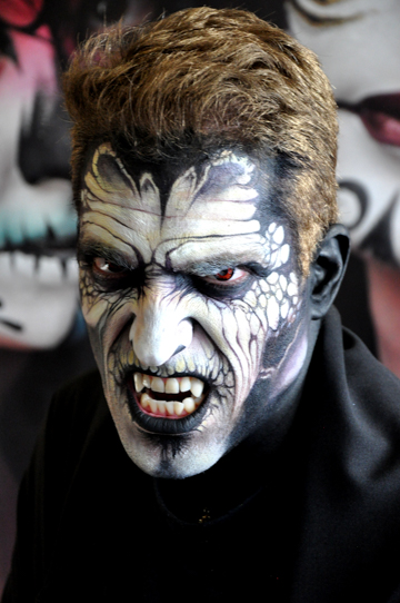man in a moster face painting in black and white